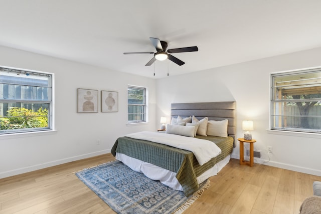 bedroom featuring multiple windows, ceiling fan, and light hardwood / wood-style floors