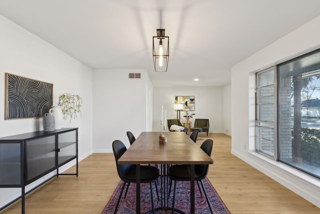 dining space with light hardwood / wood-style floors