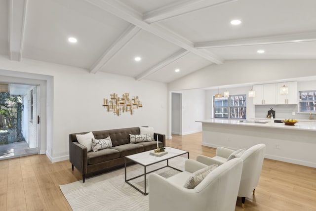 living room featuring light hardwood / wood-style floors and lofted ceiling with beams