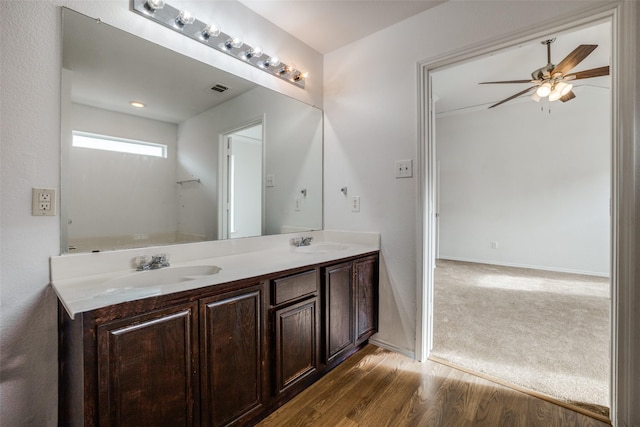 bathroom with vanity, ceiling fan, and wood-type flooring