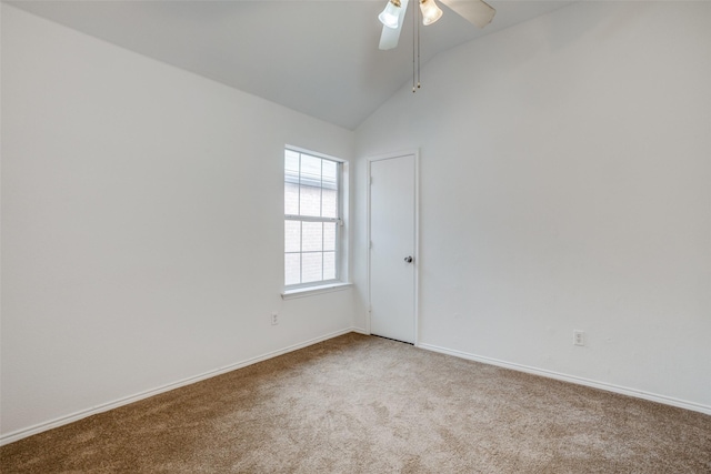 carpeted spare room with ceiling fan and lofted ceiling