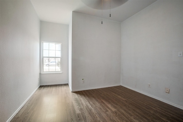 spare room featuring dark wood-type flooring