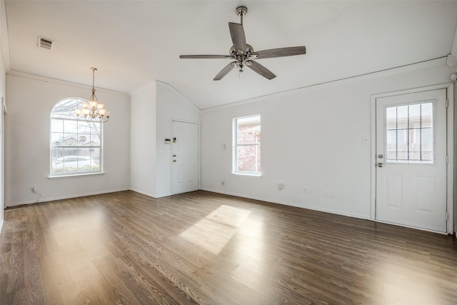 unfurnished living room featuring ceiling fan with notable chandelier, dark hardwood / wood-style floors, crown molding, and vaulted ceiling