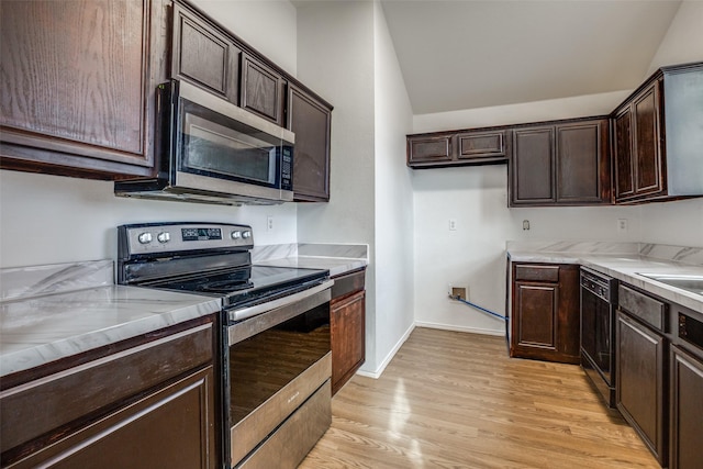 kitchen with light hardwood / wood-style flooring, dark brown cabinetry, and appliances with stainless steel finishes