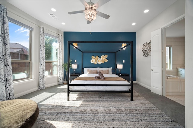 carpeted bedroom featuring baseboards, connected bathroom, visible vents, and recessed lighting