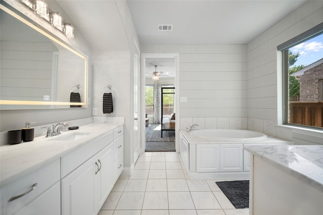 ensuite bathroom featuring visible vents, ceiling fan, ensuite bathroom, vanity, and a bath