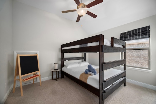 bedroom with a ceiling fan, lofted ceiling, light colored carpet, and baseboards