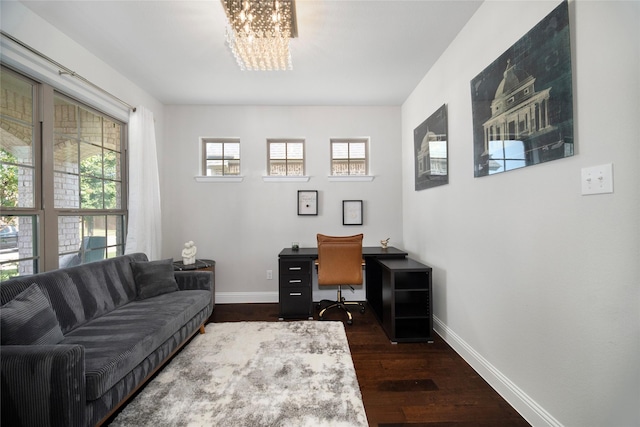 office featuring a chandelier, dark wood finished floors, and baseboards