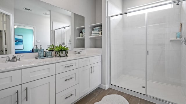 bathroom featuring vanity and an enclosed shower