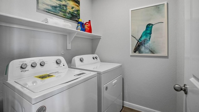 clothes washing area with separate washer and dryer