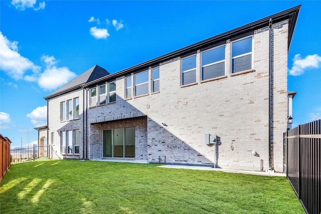 rear view of property with a lawn