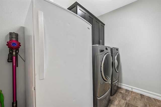 washroom with cabinets and separate washer and dryer