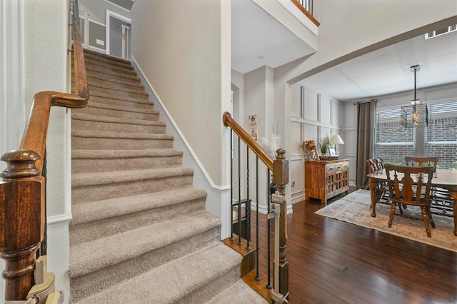 stairs featuring hardwood / wood-style floors