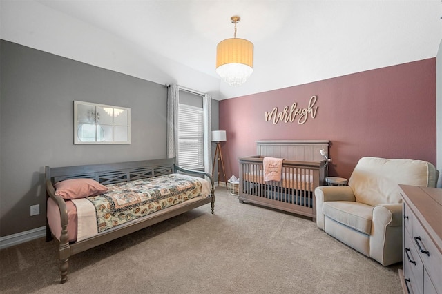 bedroom featuring light carpet and a notable chandelier