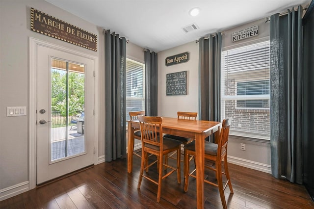 dining space with plenty of natural light and dark wood-type flooring