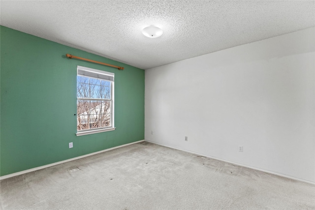 carpeted spare room with a textured ceiling