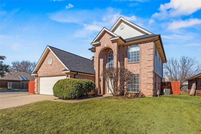 front of property featuring a garage, central air condition unit, and a front lawn