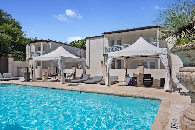 back of house with a patio area, a gazebo, and a community pool