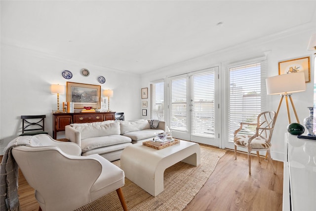 living room featuring light hardwood / wood-style flooring and ornamental molding