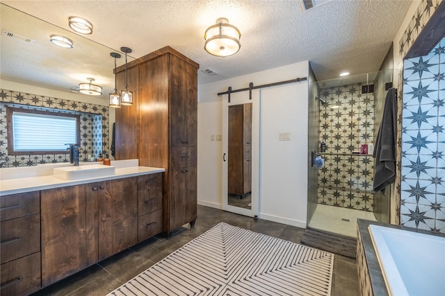 bathroom featuring vanity, shower with separate bathtub, and a textured ceiling