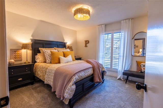 carpeted bedroom featuring a textured ceiling