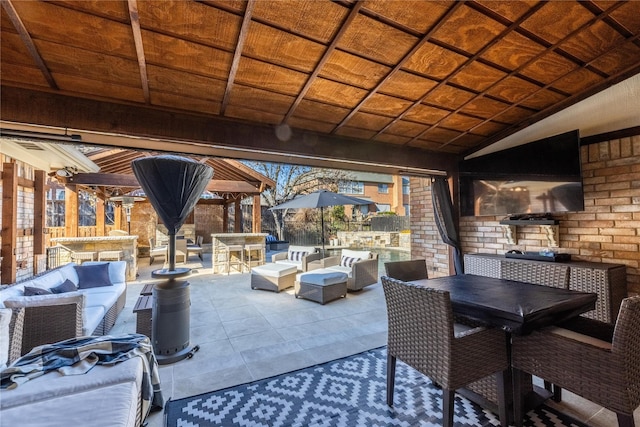 view of patio with a gazebo, exterior bar, and an outdoor hangout area