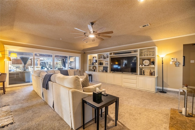 living room with ceiling fan, light colored carpet, and a textured ceiling