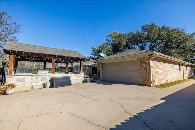 view of side of property featuring a gazebo, a garage, and an outdoor structure