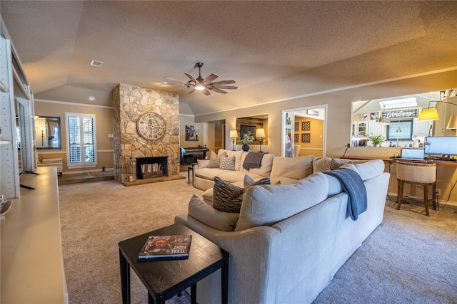 carpeted living room with ceiling fan, a fireplace, vaulted ceiling, and a textured ceiling