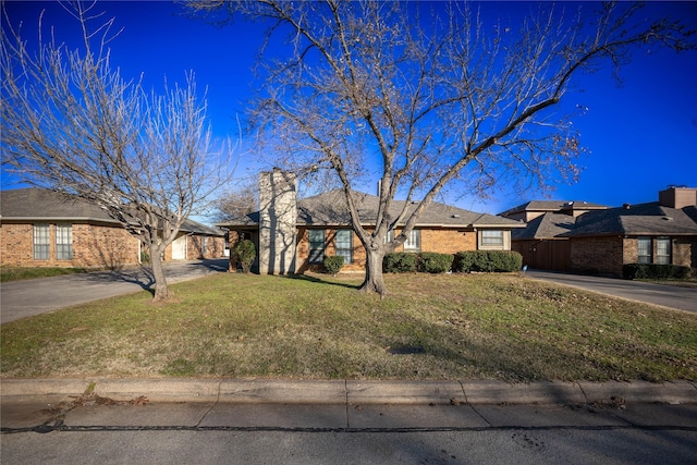 ranch-style house with a front lawn