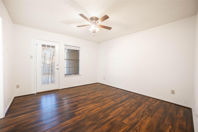 spare room with a textured ceiling, dark hardwood / wood-style floors, and ceiling fan