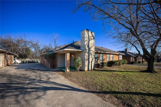 exterior space featuring a garage and a front lawn