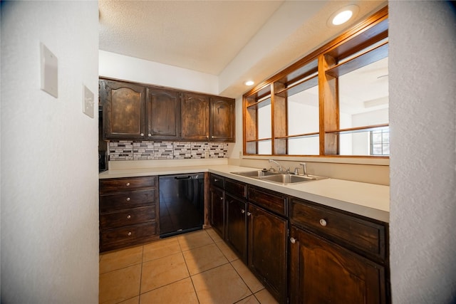 kitchen with dark brown cabinets, dishwasher, sink, tasteful backsplash, and light tile patterned floors