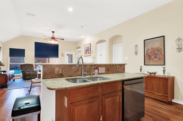 9435 Homestead Ln, Frisco, TX 75033 - kitchen with dishwashing machine, a sink, wood finished floors, open floor plan, and vaulted ceiling