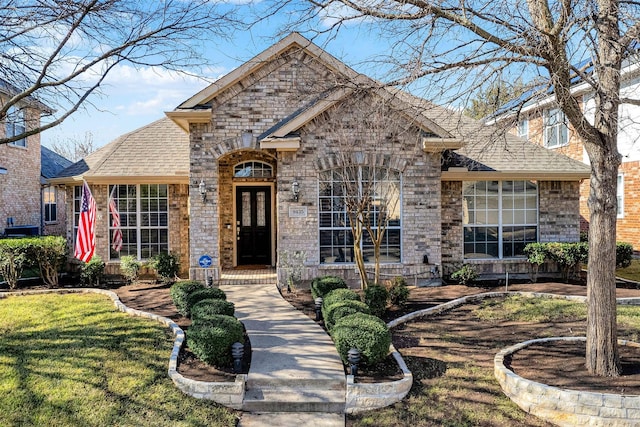 9435 Homestead Ln, Frisco, TX 75033 - view of front of house featuring brick siding, roof with shingles, and a front lawn