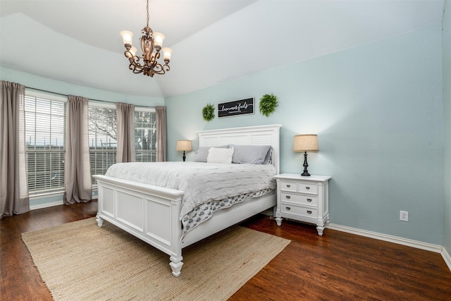 bedroom featuring dark wood-type flooring, an inviting chandelier, and vaulted ceiling