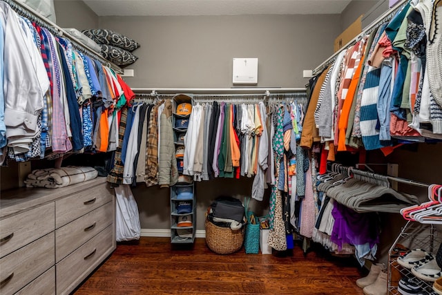 walk in closet featuring dark wood-type flooring