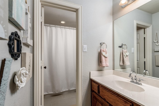 bathroom with vanity and a shower with shower curtain