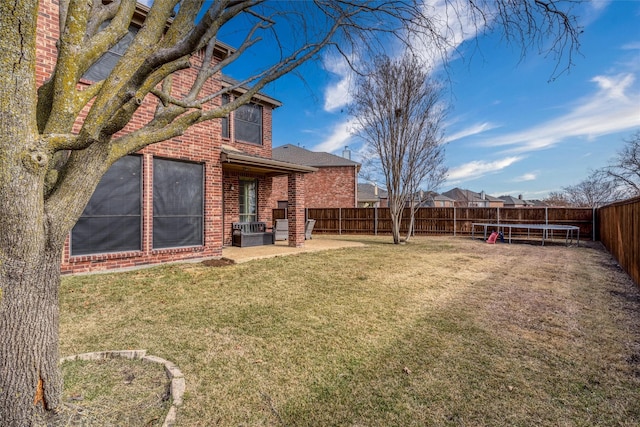 view of yard featuring a patio and a trampoline