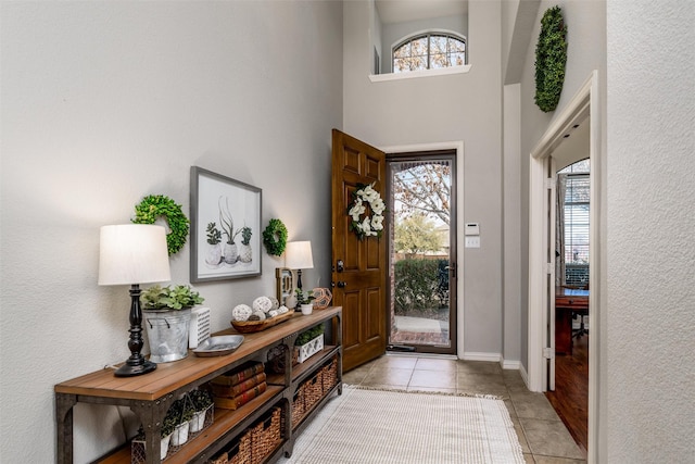 tiled foyer with a high ceiling