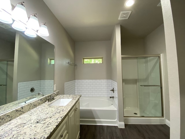 bathroom featuring hardwood / wood-style floors, vanity, and independent shower and bath