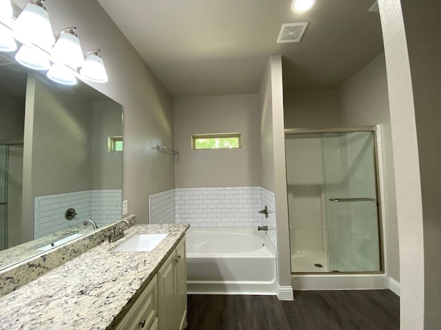 bathroom featuring vanity, hardwood / wood-style floors, and separate shower and tub