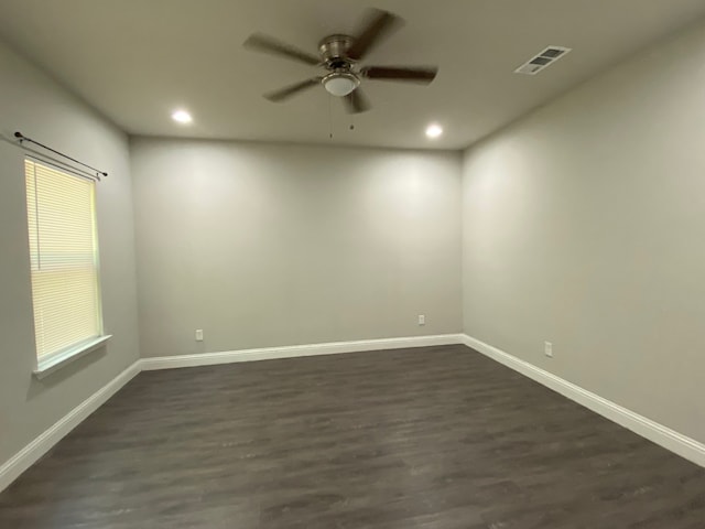 empty room featuring ceiling fan and dark hardwood / wood-style floors