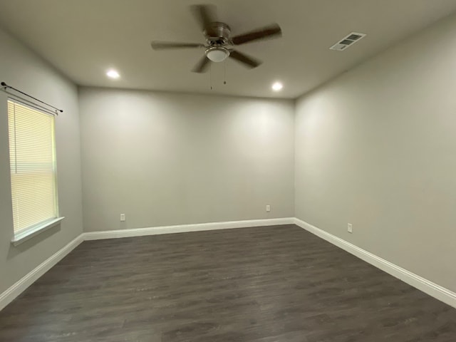 spare room with ceiling fan and dark hardwood / wood-style floors