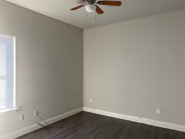 spare room with ceiling fan and dark hardwood / wood-style flooring