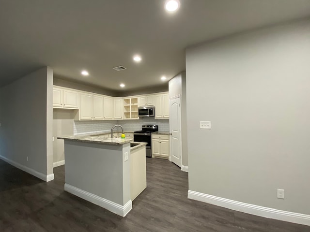 kitchen featuring light stone countertops, decorative backsplash, white cabinets, dark wood-type flooring, and stainless steel appliances