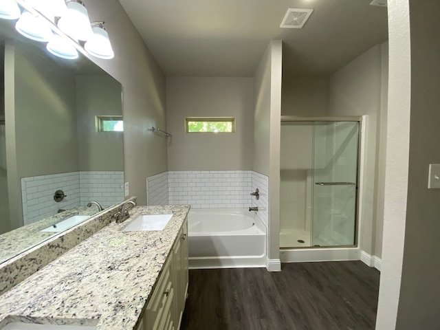 bathroom featuring hardwood / wood-style flooring, vanity, and independent shower and bath