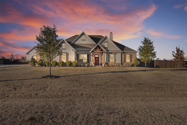 craftsman inspired home featuring a yard