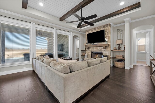 living room featuring ceiling fan, beam ceiling, a fireplace, wooden ceiling, and dark hardwood / wood-style floors