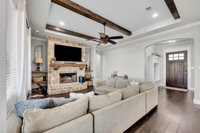 living room featuring wood ceiling, dark hardwood / wood-style floors, a stone fireplace, and a healthy amount of sunlight